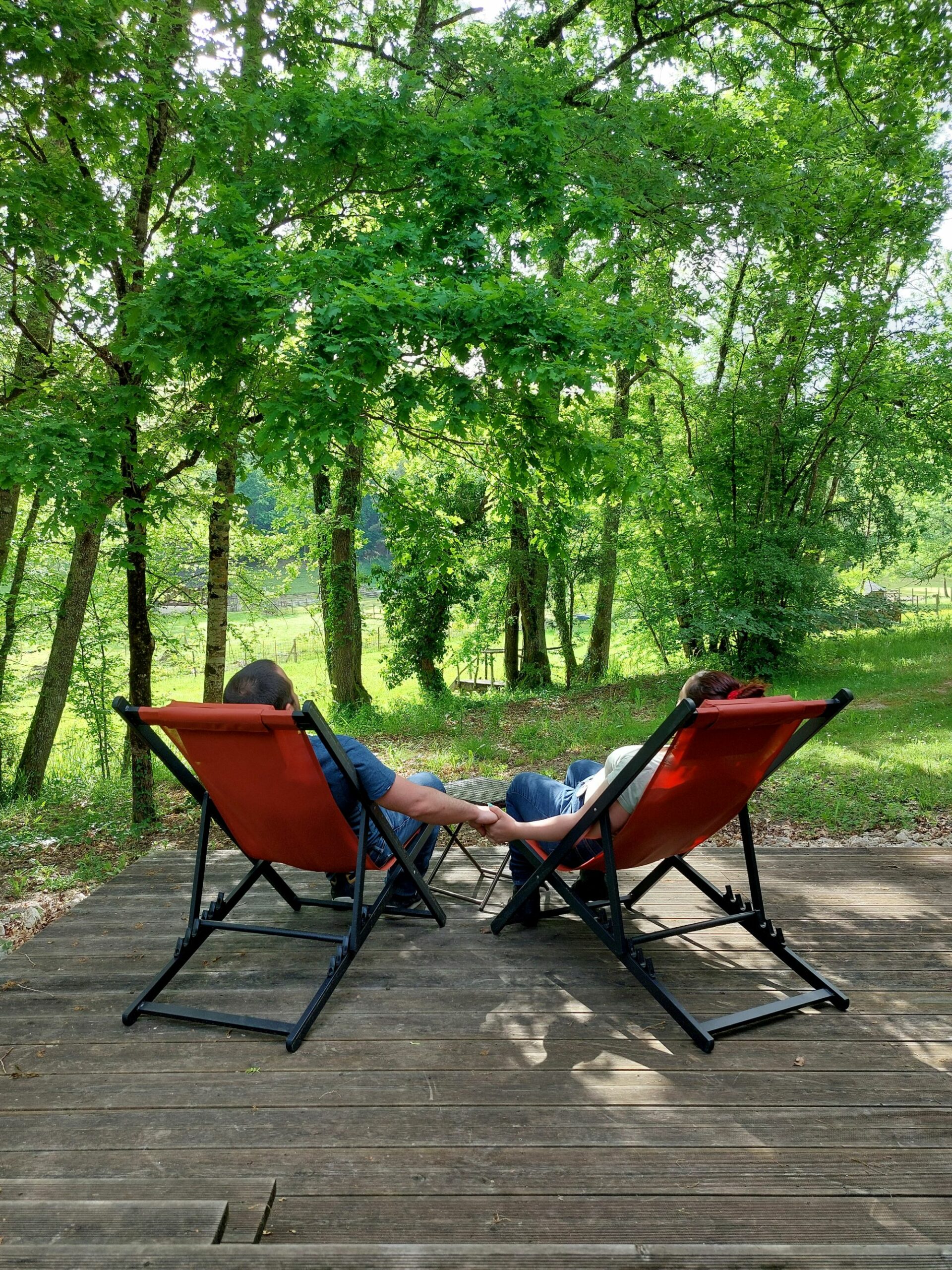 Couple adult-only se donnant la main sur deux transats